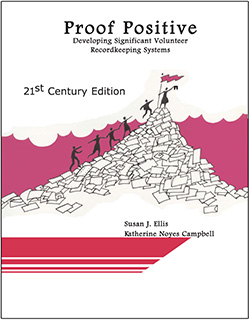 Book cover with title, stick figures walking up a pile of papers and putting flag at top